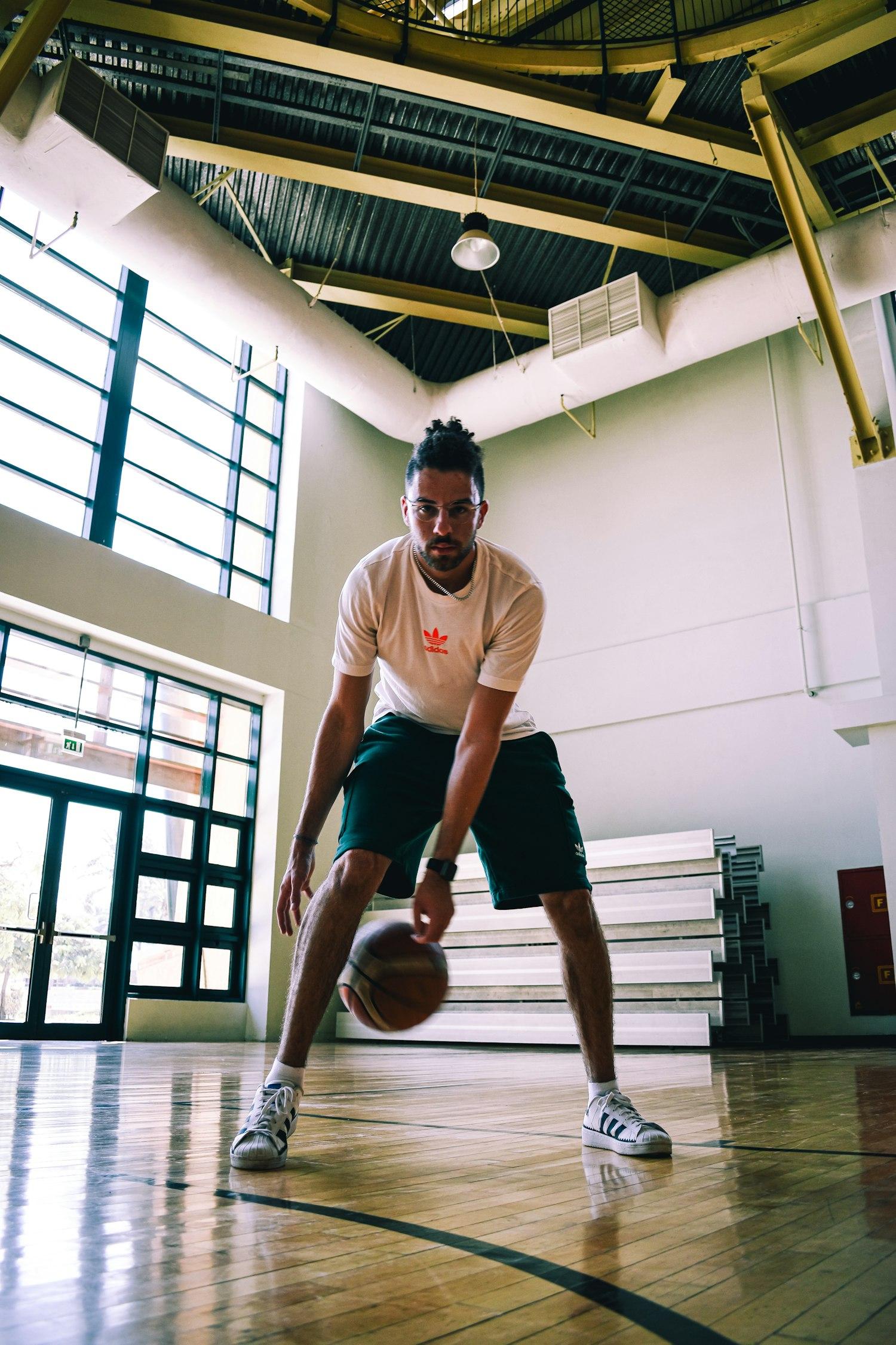 Player training, dribbling a basketball indoors